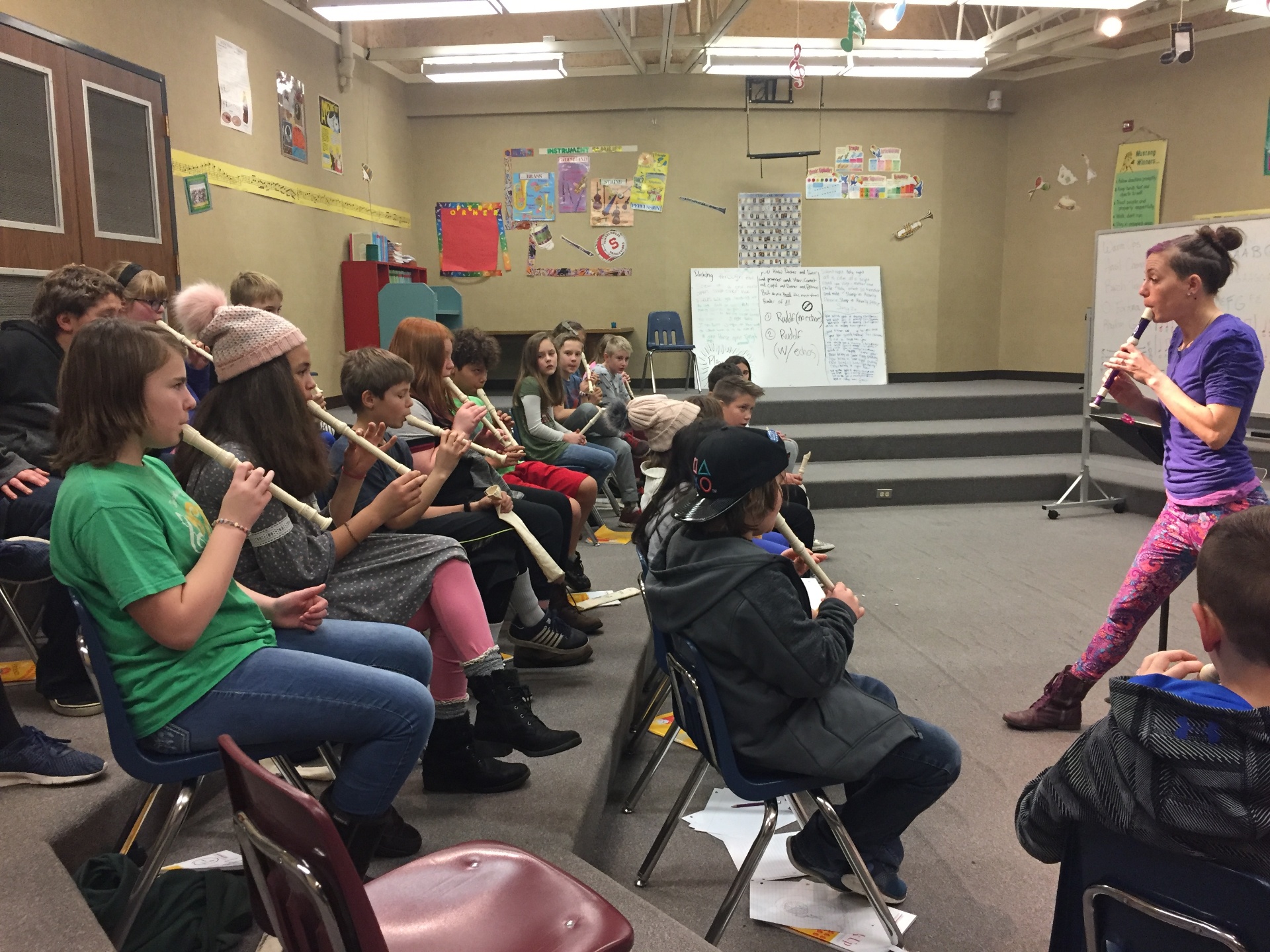 Students playing recorders together in class