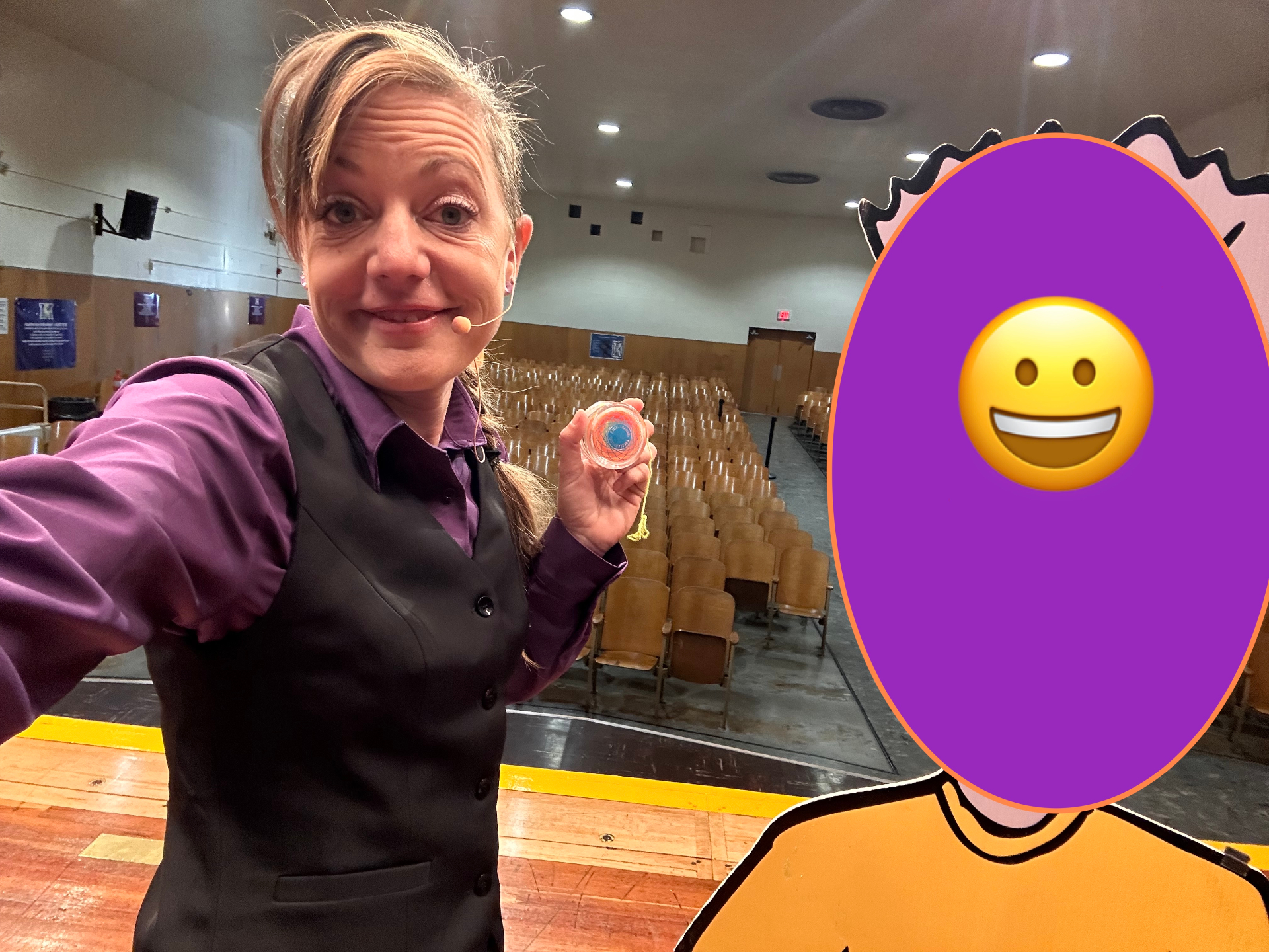 Jenifer holding a yo-yo in an empty theater, taking a selfie