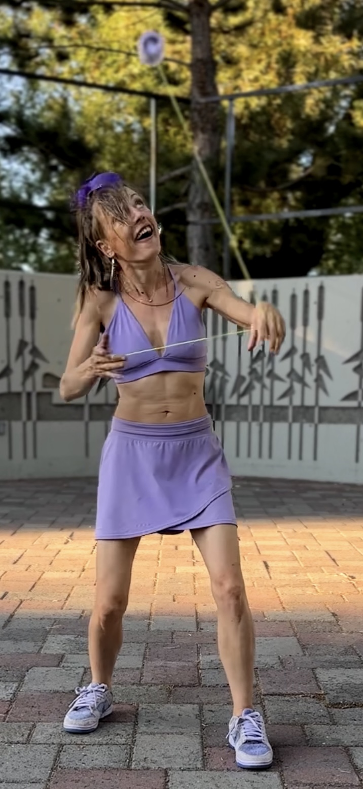 Jen Joy mid-flow with a flashing purple yo-yo